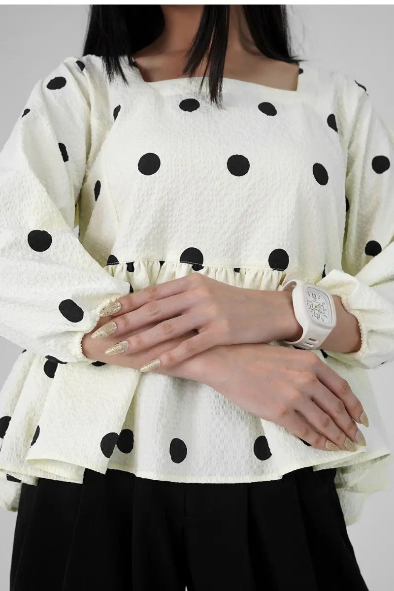 Model wearing Muse Dots peplum top