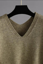Model wearing cable-knit V-neck sweater